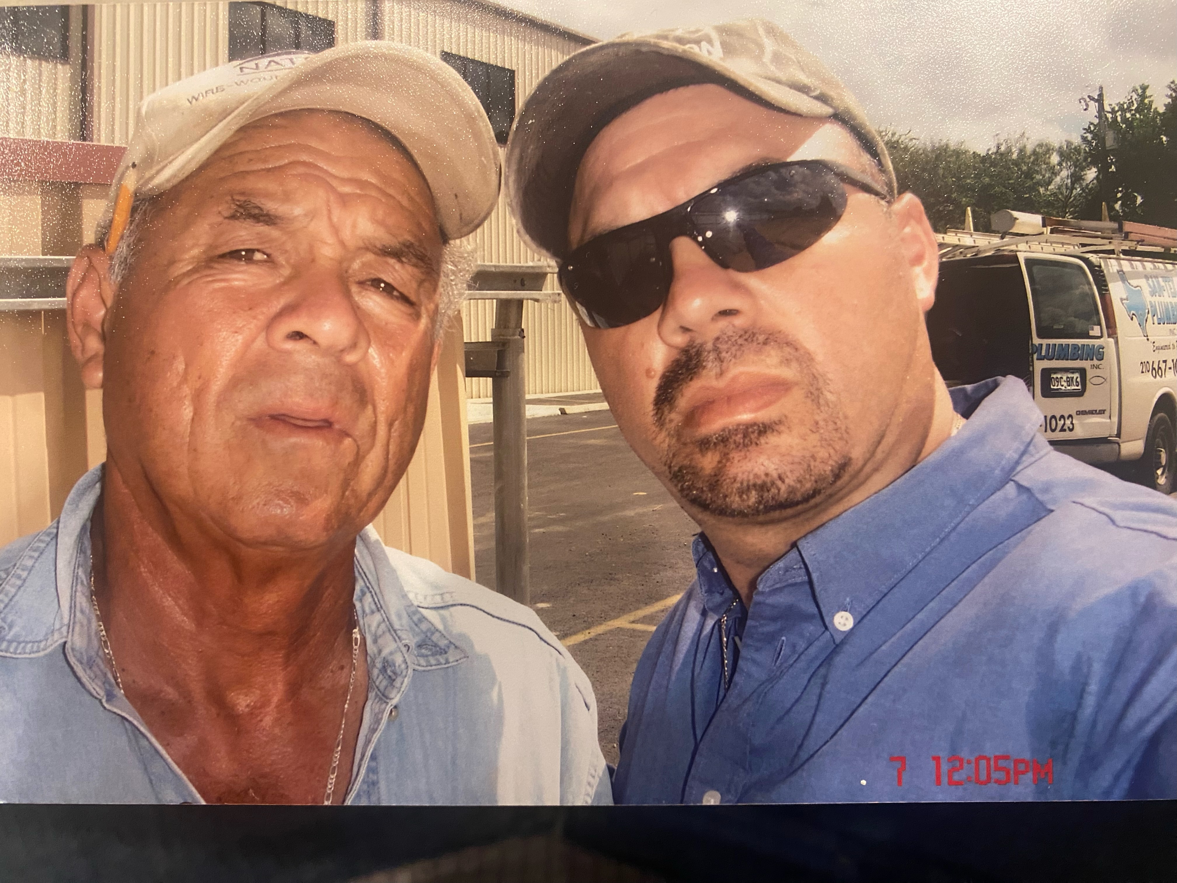 Rudy Sr. and Rudy Jr., San-Tex Plumbing founders, in front of the company van